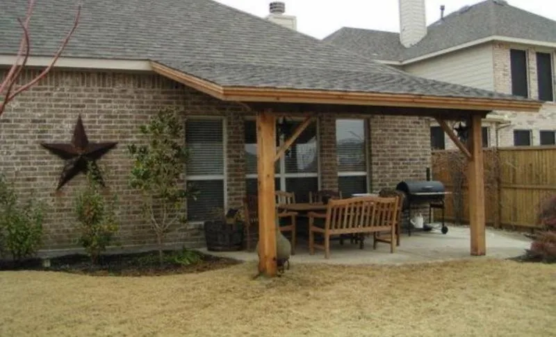 Covered patio addition with stained timber posts across the back of a home