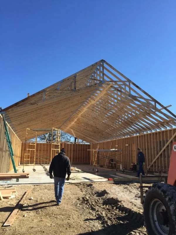 Framed walls and open roof trusses on a build site